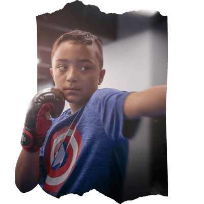 A young boy exudes confidence after learning from our self-defense camp